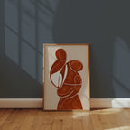 Terracotta Embrace Poster inramad ovanför en byrå i varm heminredning